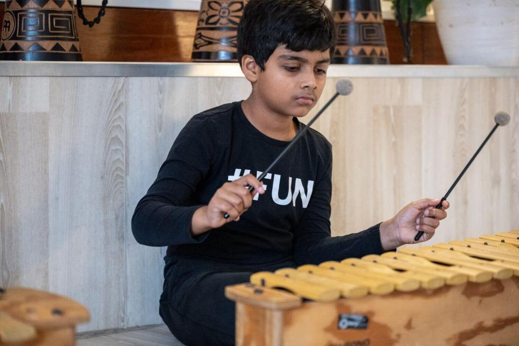 A young student playing the alto xylophone in a music lesson