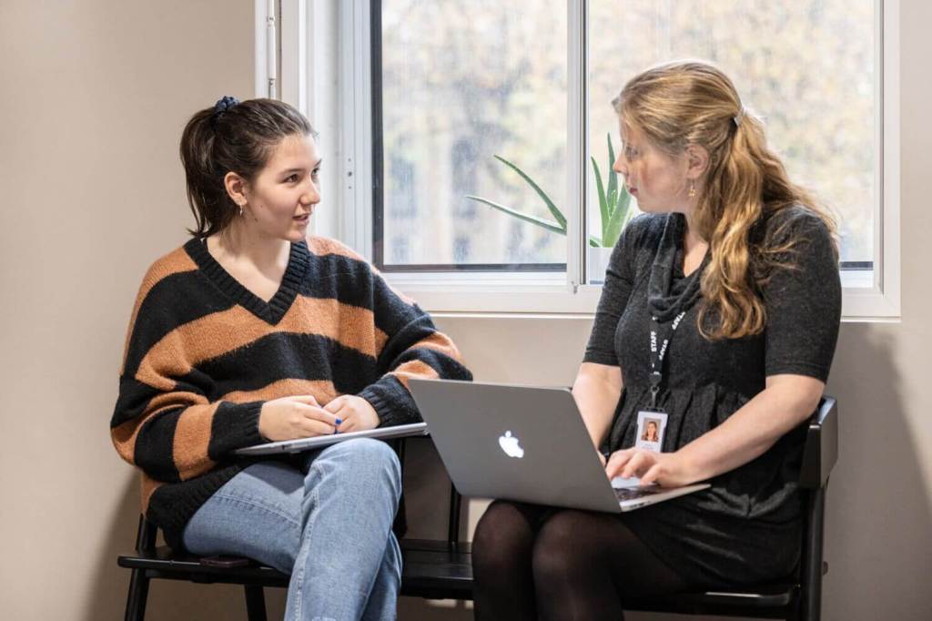 Student and teacher with laptops