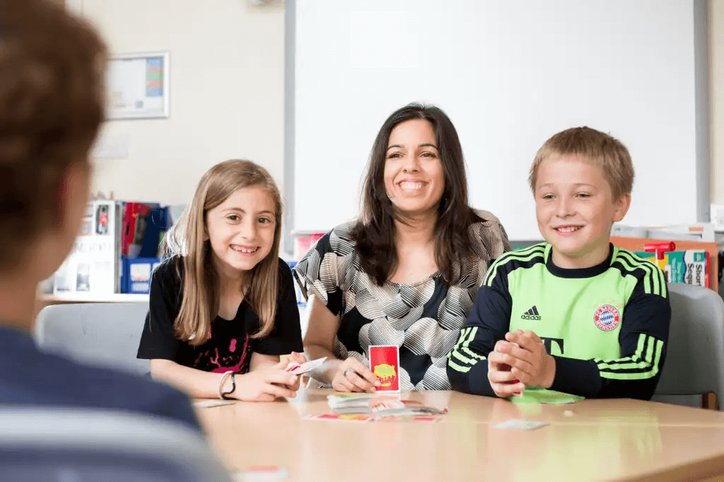 teacher with 2 students smiling