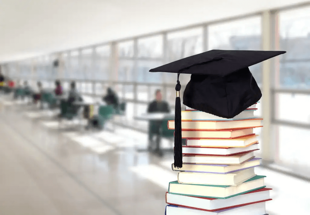 Graduation cap on top of pile of books