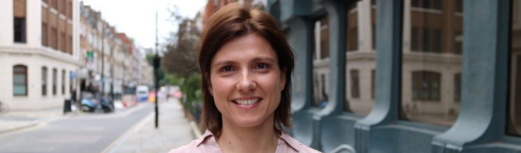 Woman standing in street smiling