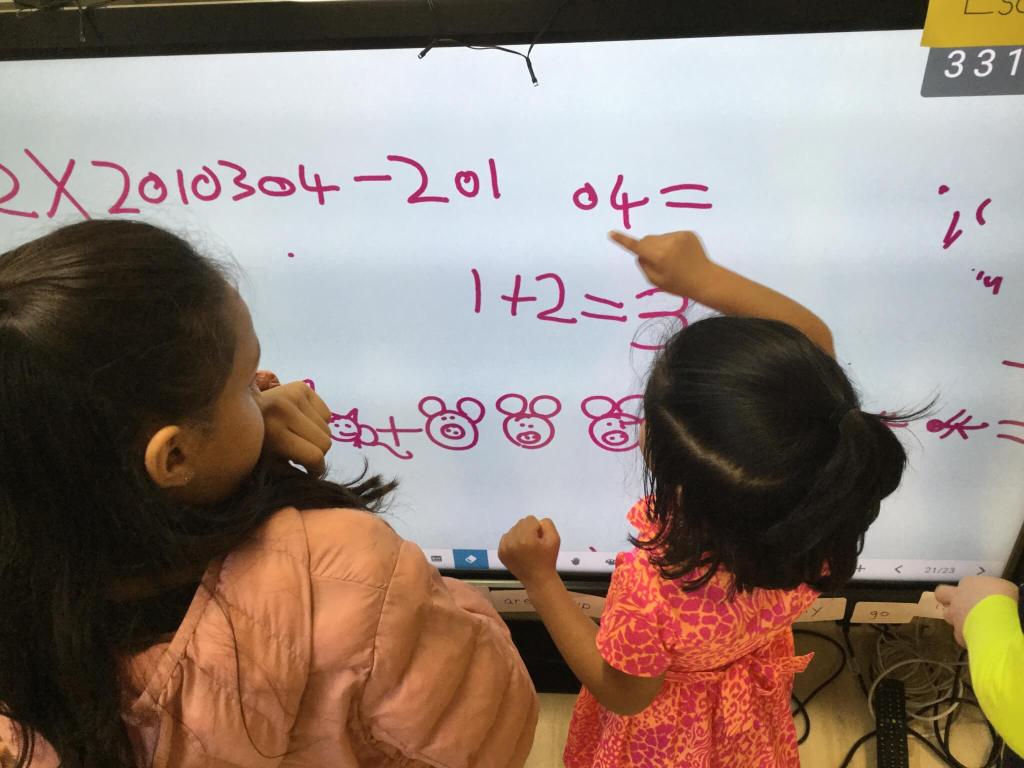 Primary students working on a mathematical equation